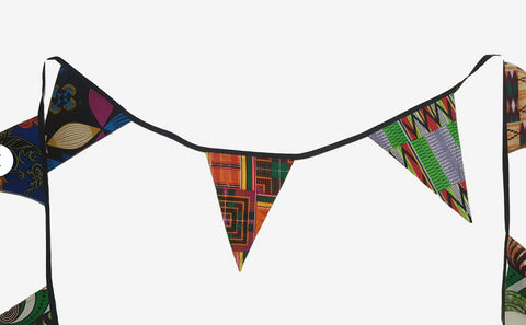 Colorful triangular flags on a white wall