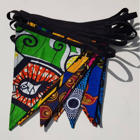 Colorful fabric pennants with intricate patterns on a white background