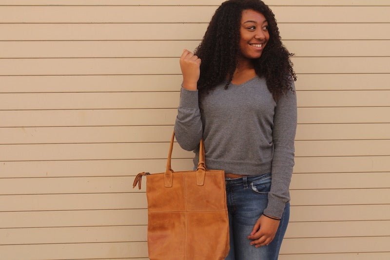 ethical fair trade genuine leather handbag on teenage african american model taken for do good shop nonprofit