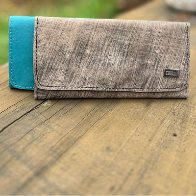 Wallet with blue accent on a wooden surface outdoors