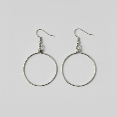 Pair of silver hoop earrings on a light gray background