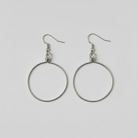 Pair of silver hoop earrings on a light gray background