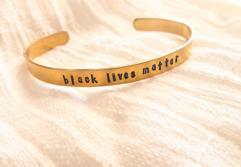black.lives.matter.gold.cuff.bracelet.hand.stamped.by.women.survivors.sold.at.do.good.shop.ethical.gifts